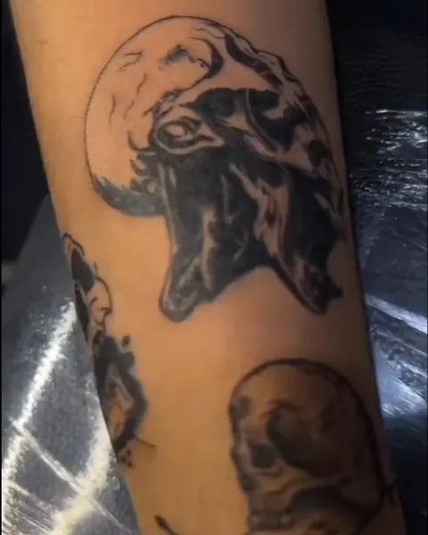 Blackwork skull tattoos on a forearm