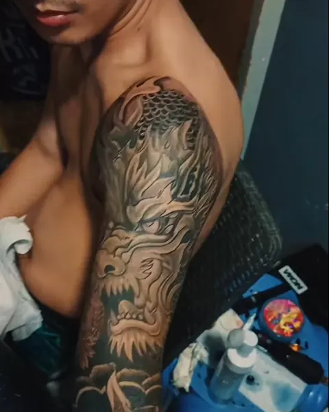 Black and grey Japanese dragon sleeve on a man's arm